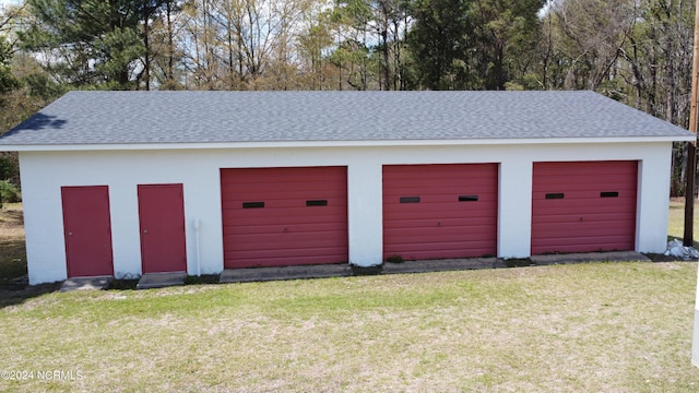 garage featuring a lawn