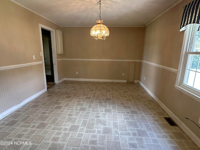 spare room with a chandelier