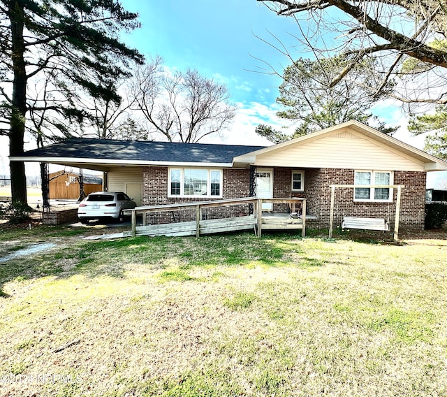 view of front of property with a front lawn and a carport