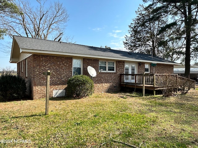 exterior space with a deck and a lawn