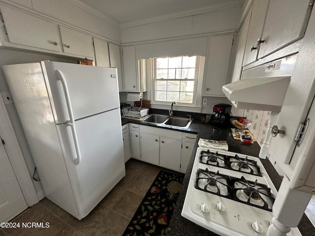 kitchen with sink, dark tile floors, white refrigerator, and white cabinetry