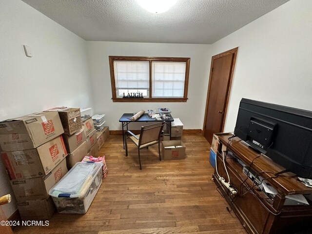 miscellaneous room with hardwood / wood-style flooring and a textured ceiling