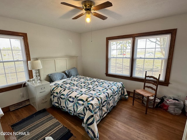 bedroom featuring ceiling fan and dark hardwood / wood-style floors