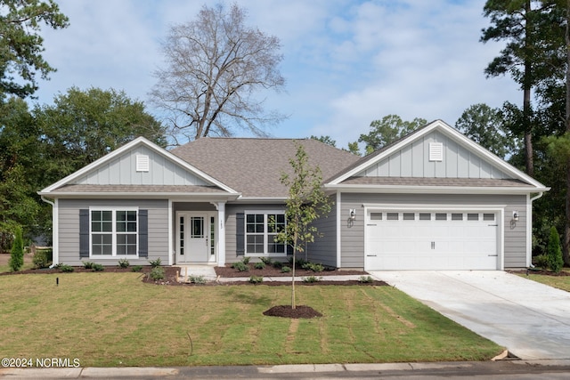 view of front of home featuring a garage and a front lawn