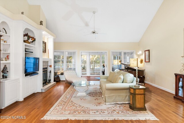 kitchen featuring light wood-type flooring, white cabinets, an island with sink, and stainless steel appliances