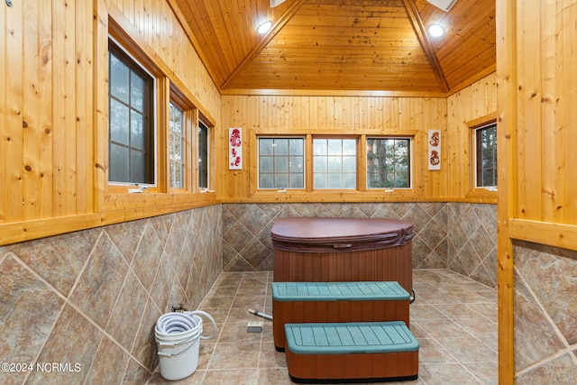 bathroom with tile walls, wood ceiling, vaulted ceiling, and tile patterned flooring