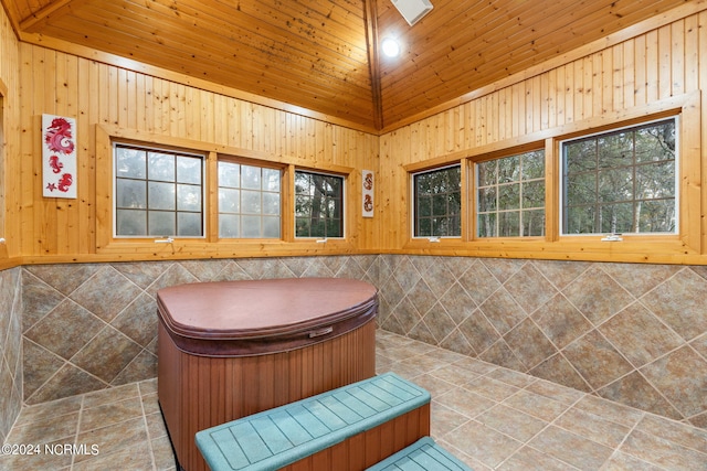 bathroom with lofted ceiling, tile patterned floors, tile walls, wood walls, and wooden ceiling