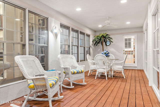 sunroom / solarium featuring ceiling fan