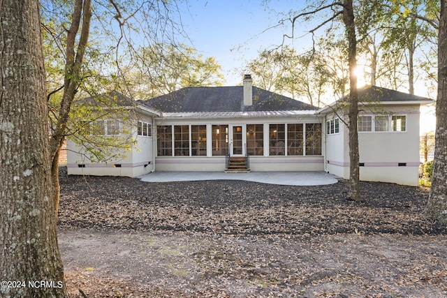 back of house featuring a patio and a sunroom