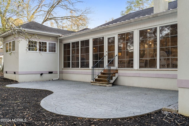 back of house with a sunroom and a patio area