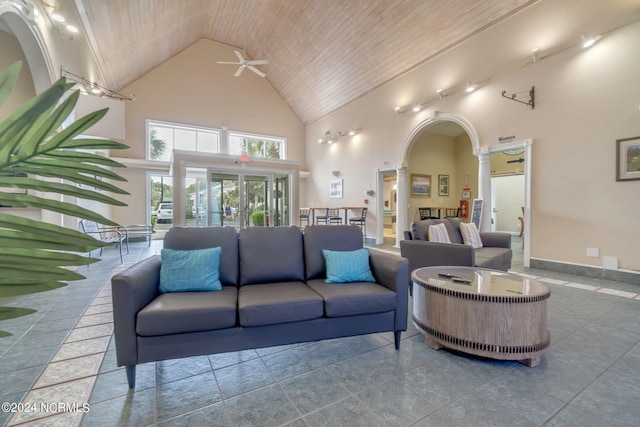 living room with ornate columns, high vaulted ceiling, ceiling fan, and wood ceiling