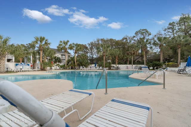 view of swimming pool with a patio