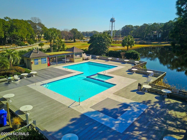 view of pool with a community hot tub, a water view, and a patio area