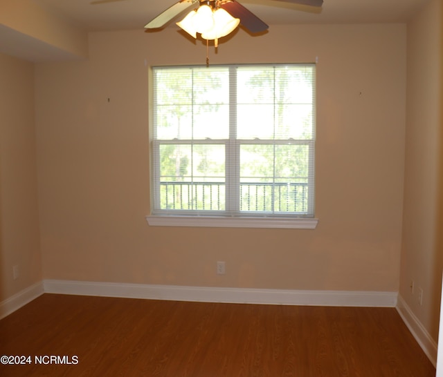 spare room with ceiling fan and dark hardwood / wood-style flooring