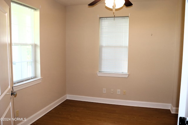 unfurnished room featuring ceiling fan and dark wood-type flooring