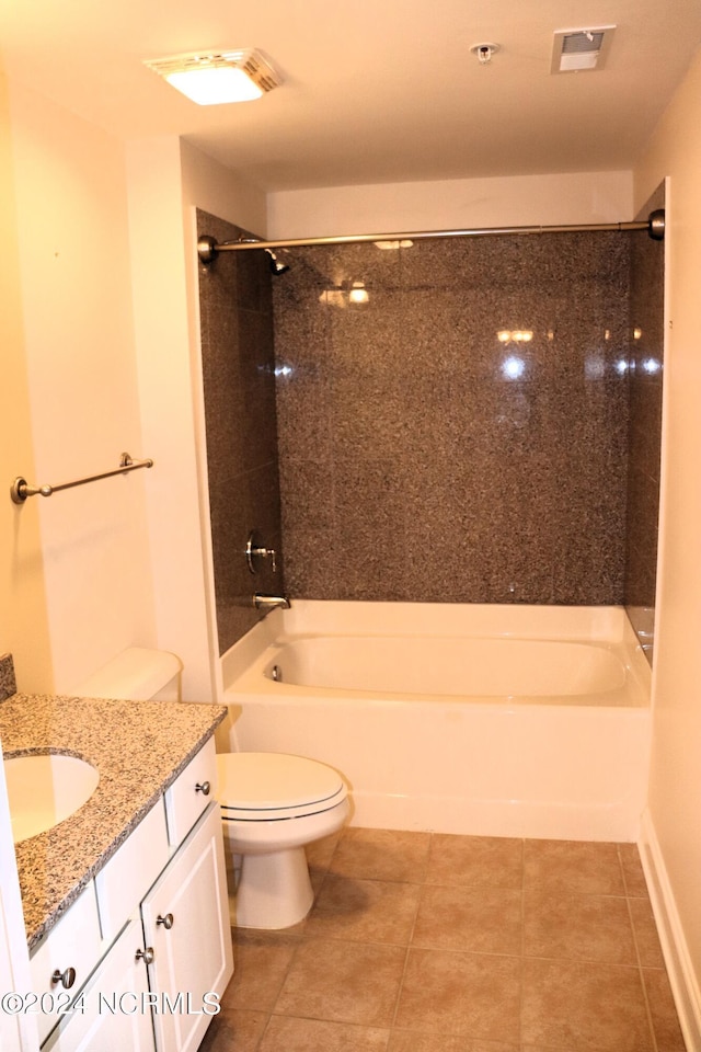 full bathroom featuring toilet, vanity, tiled shower / bath combo, and tile patterned flooring