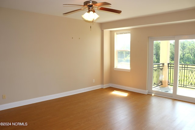 unfurnished room featuring ceiling fan and hardwood / wood-style floors