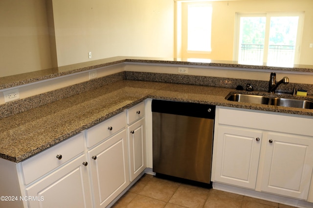 kitchen featuring dishwasher, white cabinets, dark stone counters, and sink