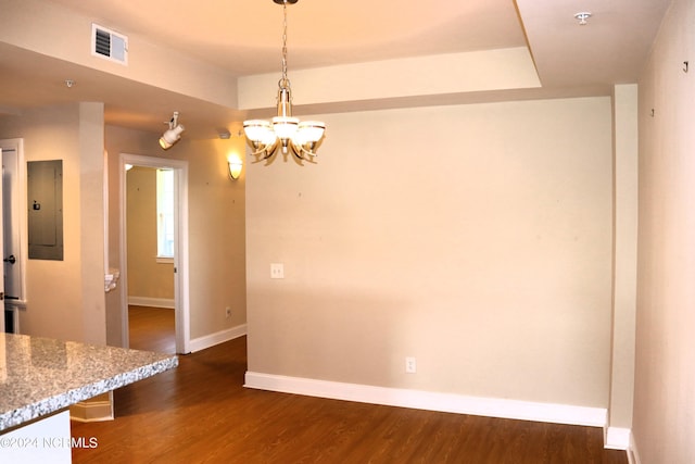 unfurnished dining area with electric panel, a chandelier, and dark hardwood / wood-style flooring