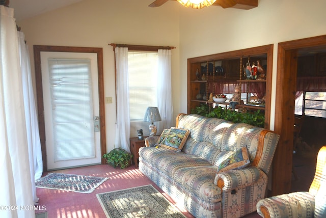 carpeted living room with ceiling fan, lofted ceiling, and a wealth of natural light