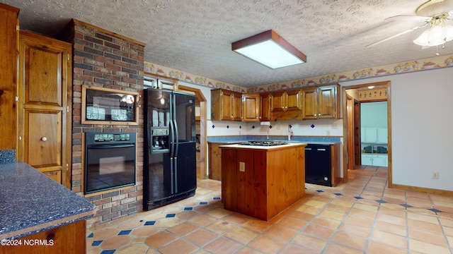 kitchen with ceiling fan, a kitchen island, black appliances, and light tile flooring