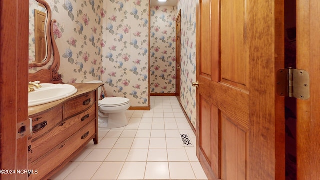 bathroom featuring toilet, tile floors, and vanity