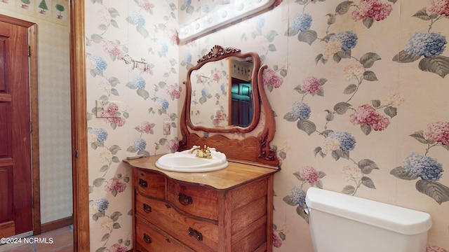 bathroom featuring toilet and vanity