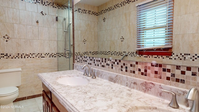 bathroom featuring tile flooring, toilet, vanity, backsplash, and tile walls