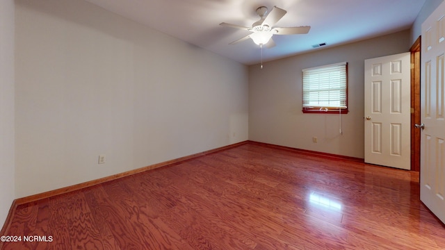 empty room featuring ceiling fan and light wood-type flooring