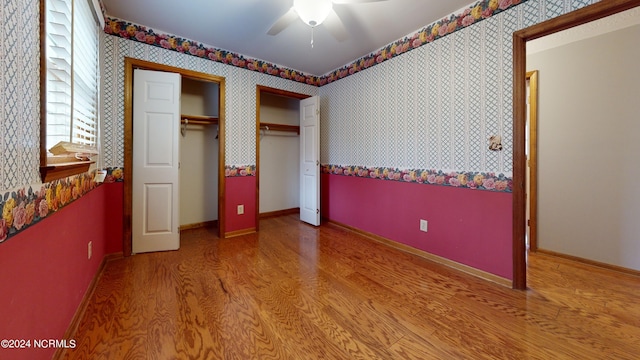 unfurnished bedroom featuring ceiling fan and hardwood / wood-style floors