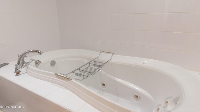 bathroom featuring tiled tub