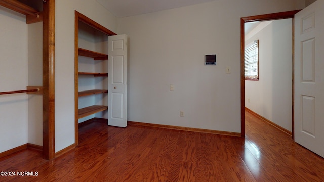 unfurnished bedroom featuring dark hardwood / wood-style flooring