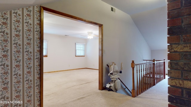 hallway with light colored carpet