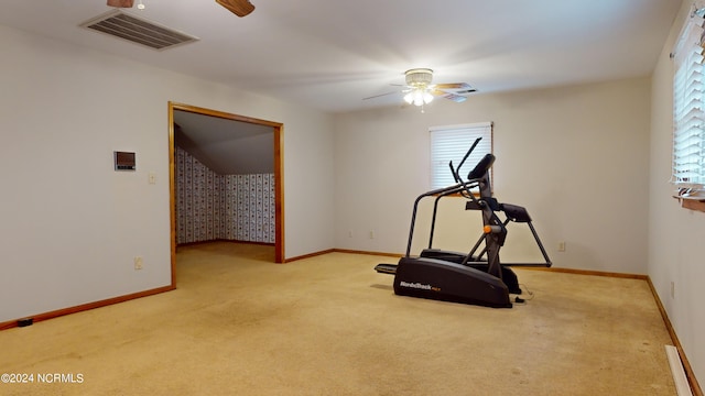 exercise room featuring light colored carpet and ceiling fan