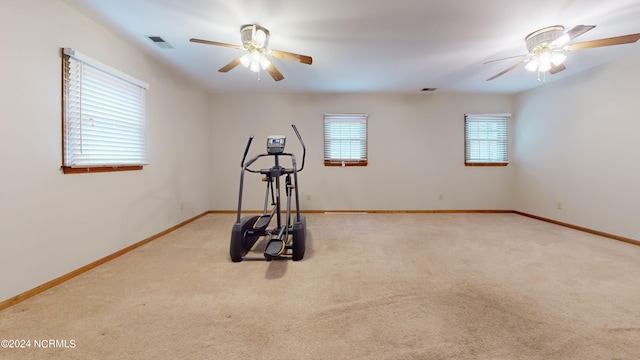 interior space with light carpet, ceiling fan, and a wealth of natural light