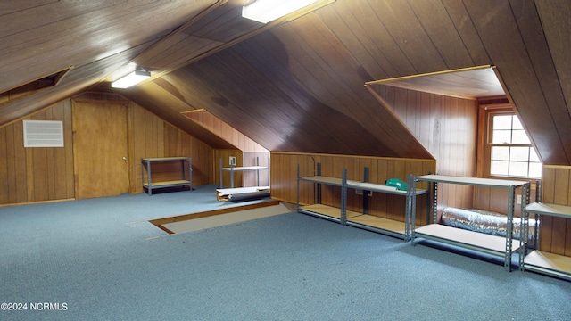 bonus room with lofted ceiling, dark carpet, wood walls, and wooden ceiling