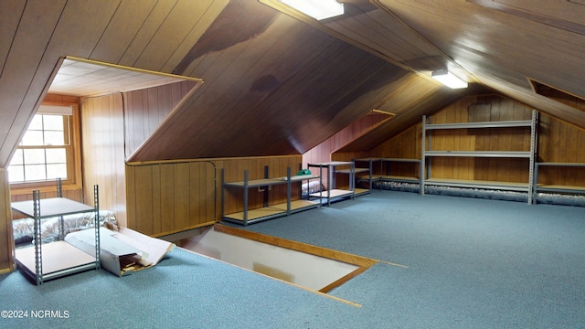 additional living space with wooden walls, dark colored carpet, wood ceiling, and vaulted ceiling