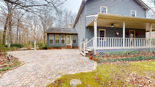 exterior space with ceiling fan and a porch