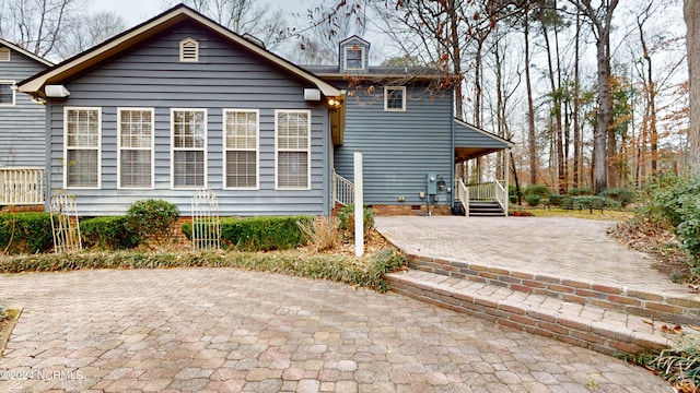 rear view of property featuring a patio area