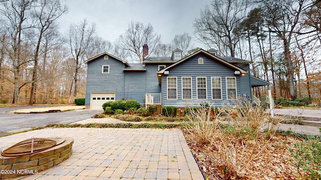 rear view of house with a garage