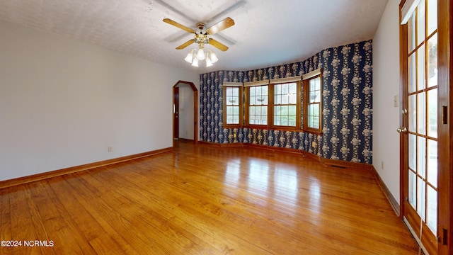 unfurnished room with ceiling fan and light hardwood / wood-style floors