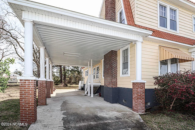 view of patio / terrace with covered porch and a carport