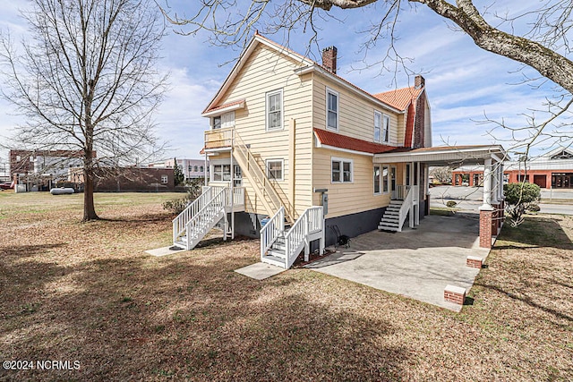 rear view of property with a carport