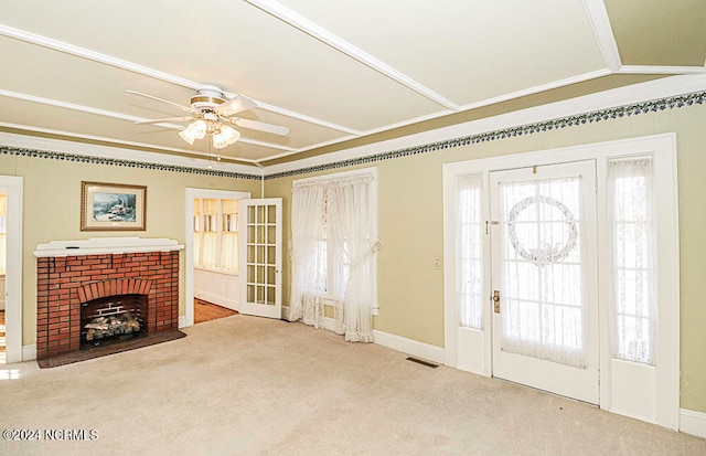 unfurnished living room featuring ornamental molding, plenty of natural light, ceiling fan, and a fireplace