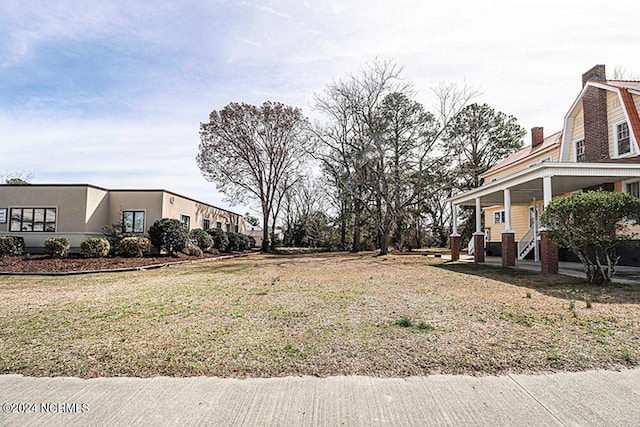 view of yard featuring covered porch