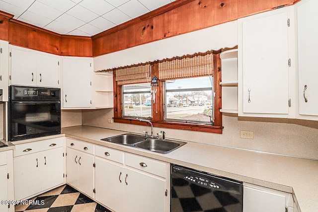 kitchen featuring light tile floors, black appliances, white cabinets, backsplash, and sink