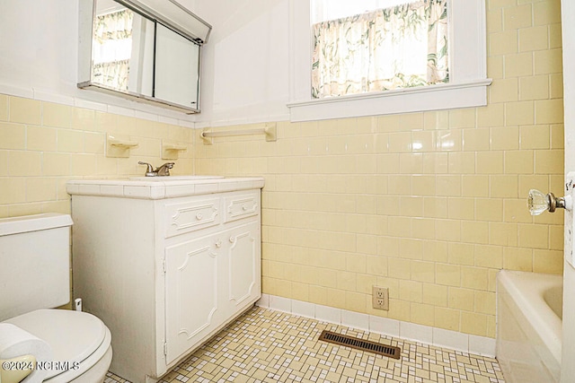 bathroom featuring tile walls, toilet, and tile floors