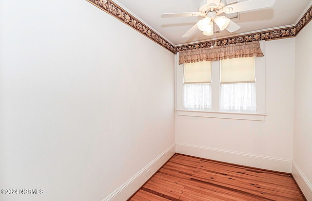 empty room with ceiling fan and hardwood / wood-style flooring