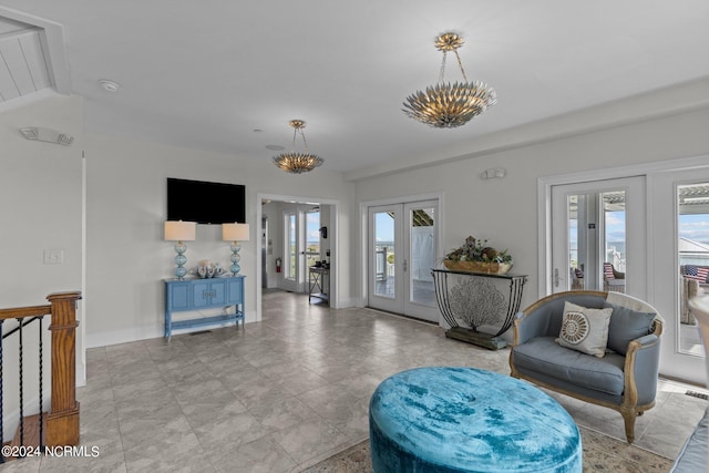 living room with french doors, lofted ceiling, and a notable chandelier