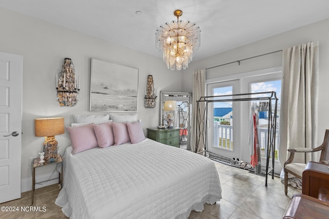 bedroom featuring light tile patterned flooring, a notable chandelier, and access to outside